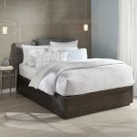 Mattress accessories: an inviting bed with sheets and pillows in a bedroom