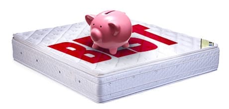 A piggy bank on a mattress with the word "Best" written on it