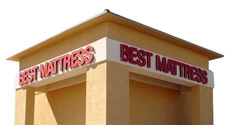 A building with Best Mattress signage on two sides