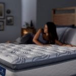 Woman laying on a Serta Perfect Sleeper mattress