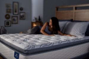 A woman laying on a Perfect Sleeper mattress