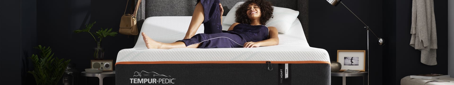 Woman laying on a TEMPUR-ProAdapt® mattress