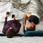Couple laying in bed relaxing comfortably