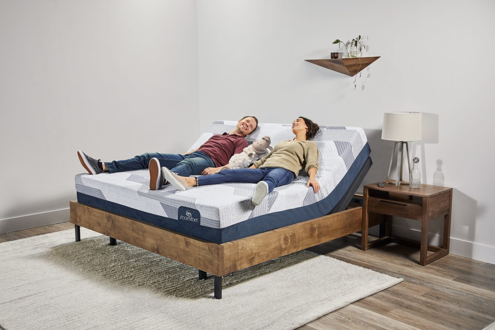 Man and woman laying on an iComfort mattress adjustable bed