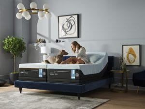 Woman and dog sitting on a TEMPUR-LUXEbreeze mattress