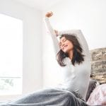 Woman stretching after best night's sleep