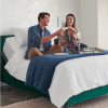 couple sitting on an iComfort mattress eating food