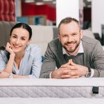 Couple laying on mattress in a mattress store