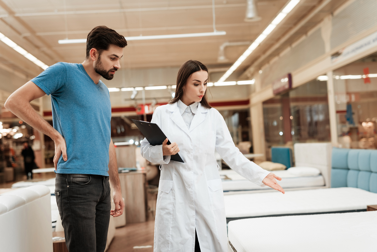 Sleep expert helping man purchase a mattress