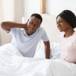 Couple in bed after uncomfortable sleep