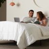 Man and woman laying in purple adjustable bed