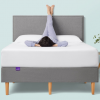 Woman with feet up on wall laying on Purple mattress and bed frame