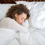 Woman sleeping in comfortable bed