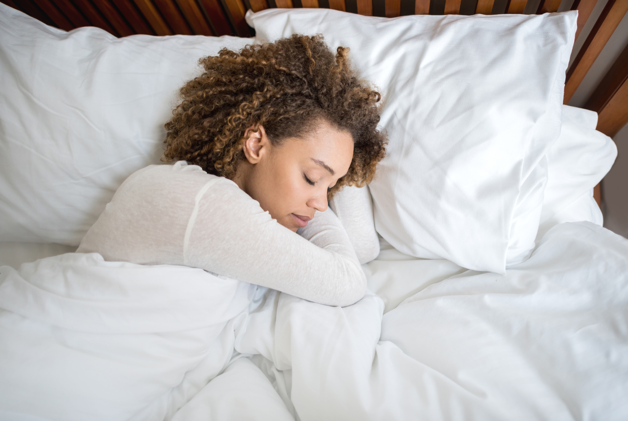 Woman sleeping in comfortable bed