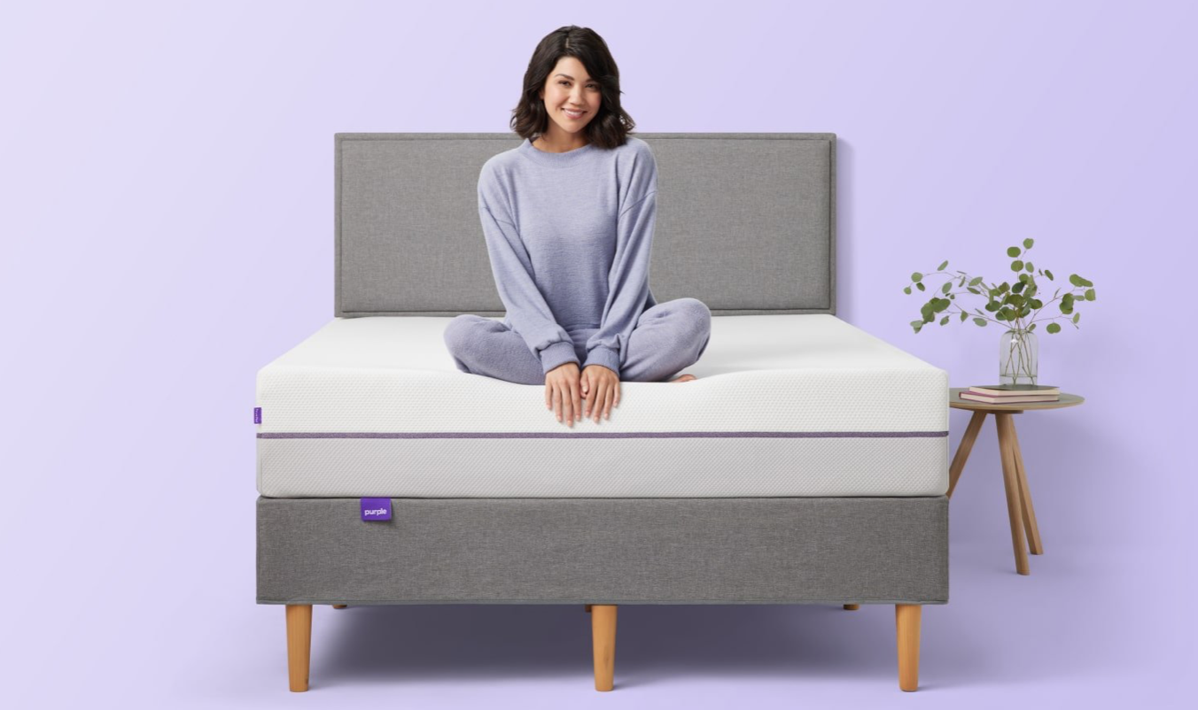 A woman sitting on a Purple Mattress