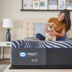 Sealy Posturepedic Hybrid Plus mattress with woman and dog