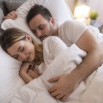 Couple sleeping comfortably in bed